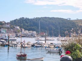 A view of boats in a harbor with hills and buildings in the background at 2 The Old School House