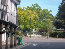 An outdoor view of Royal Avenue Gardens with a fountain and sign in the foreground at 2 The Old School House