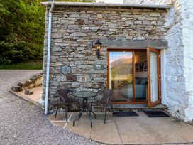 An outdoor area with a table and chairs at Wren's Nest Thornthwaite near Braithwaite