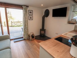 A living room with a sofa and television at Wren's Nest in Thornthwaite near Braithwaite