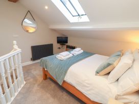 A bedroom with a bed and television at Wren's Nest Thornthwaite near Braithwaite