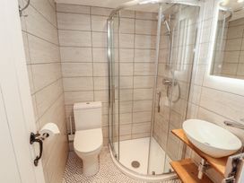 A bathroom with a shower and sink at Wren's Nest in Thornthwaite near Braithwaite