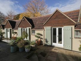 Exterior view of cottages with plants and doors at Cottage - 1 bedroom Broadway