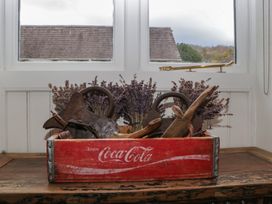 A basket with lavender and wooden items on a table at Cottage - 1 bedroom Broadway