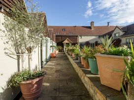 A pathway with potted plants and trees at Cottage - 1 bedroom Broadway