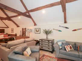 A living room with a sofa and coffee table at Garden Cottage in Saintbury near Broadway