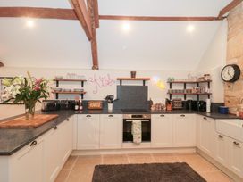 A kitchen with cabinets and countertop at Garden Cottage in Saintbury near Broadway