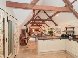A kitchen with a countertop and dining chair at Garden Cottage Saintbury near Broadway