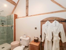 A bathroom with a shower and towels at Garden Cottage in Saintbury near Broadway