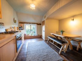 A kitchen with dining table and bench seating at 5 St. Michaels Close in Framlingham
