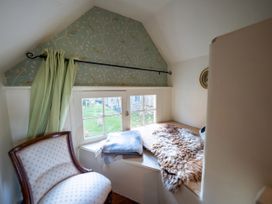 A snug area with a window seat and an armchair at 5 St. Michaels Close Framlingham