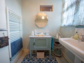 A bathroom with a sink and mirror at 5 St. Michaels Close Framlingham