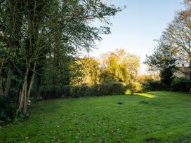 A garden with trees and grass at 5 St. Michaels Close Framlingham