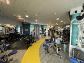 A gym area with various fitness equipment at Satinwood in White Cross near Newquay