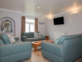 A living room with sofas and a television at Satinwood, White Cross near Newquay