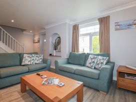 A living room with sofas and a coffee table at Satinwood in White Cross near Newquay