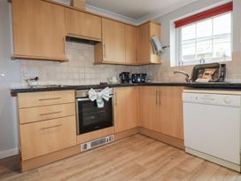 A kitchen with appliances including a sink and oven at Satinwood in White Cross near Newquay