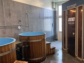 A spa area with wooden tubs and a sauna at Satinwood in White Cross near Newquay
