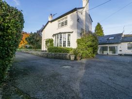 A white two story house with large windows and a driveway at The Coach House in Abergavenny