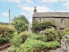 A garden surrounding a stone house at Old Cottage in Oxen Park near Ulverston