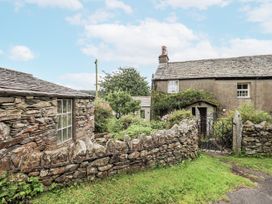 An outdoor area with a cottage and garden at The Old Cottage in Oxen Park near Ulverston