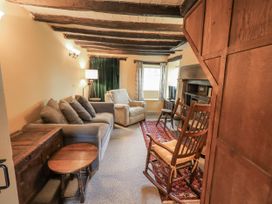 A living room with a sofa and rocking chair at Old Cottage in Oxen Park near Ulverston