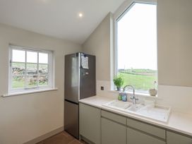 A kitchen with a refrigerator and sink at Old Cottage Oxen Park near Ulverston