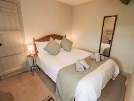 A bedroom with a bed and towels on it at Old Cottage in Oxen Park near Ulverston