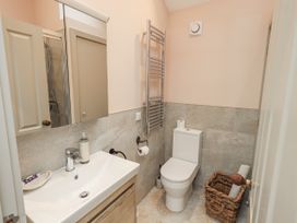 A bathroom with sink, toilet, and towel rack at The Old Cottage in Oxen Park near Ulverston