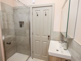 A bathroom with a shower and sink at Old Cottage in Oxen Park near Ulverston