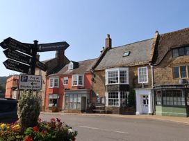 A street with direction signs and old buildings at Bobby's Lodge in South Chard