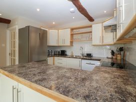A kitchen with appliances and countertops at Stable Cottage in Broadway