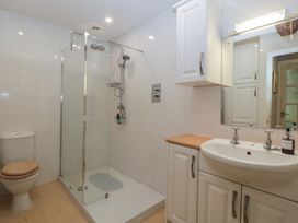 A bathroom with a shower and sink at Stable Cottage, Broadway