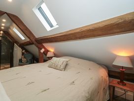 A bedroom with a bed and bedside lamps at Stable Cottage in Saintbury near Broadway