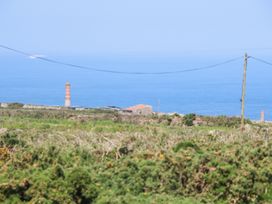 A coastal landscape with greenery a stone building and sea view at Little Victory in Pendeen