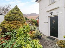 An entrance door with plants and shrubs outside at Maiden Moor in Grange near Keswick