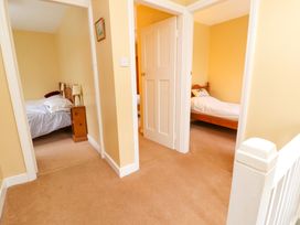A hallway with doors leading to two bedrooms with single beds at Maiden Moor in Grange near Keswick