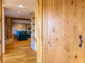 A living room view with a sofa and shelves at Heathmoor in Horrabridge