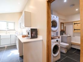 A kitchen with washing machine and dryer at Heathmoor in Horrabridge