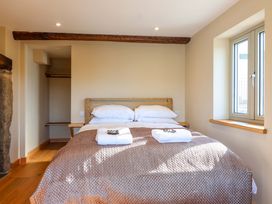 A bedroom with a bed and a window at Heathmoor in Horrabridge