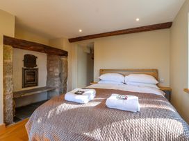 A bedroom with a bed and fireplace at Heathmoor in Horrabridge