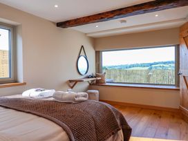 A bedroom with a bed and window at Heathmoor in Horrabridge