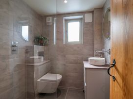A bathroom with a toilet sink and shower at Heathmoor in Horrabridge