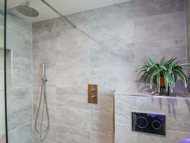 A shower area with tiles and a plant at Heathmoor in Horrabridge