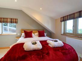 A bedroom with a bed and pillows at Heathmoor in Horrabridge