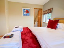 A bedroom with a bed and towels at Heathmoor in Horrabridge