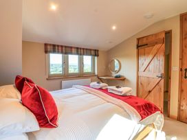 A bedroom with a bed and door at Heathmoor in Horrabridge
