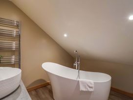 A bathroom with a bathtub and sink at Heathmoor in Horrabridge