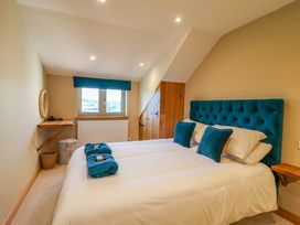 A bedroom with a bed and a shelf at Heathmoor in Horrabridge