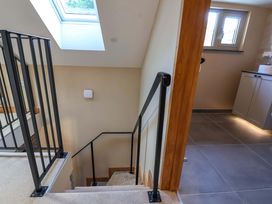 A staircase with a skylight and kitchen cabinetry at Heathmoor in Horrabridge